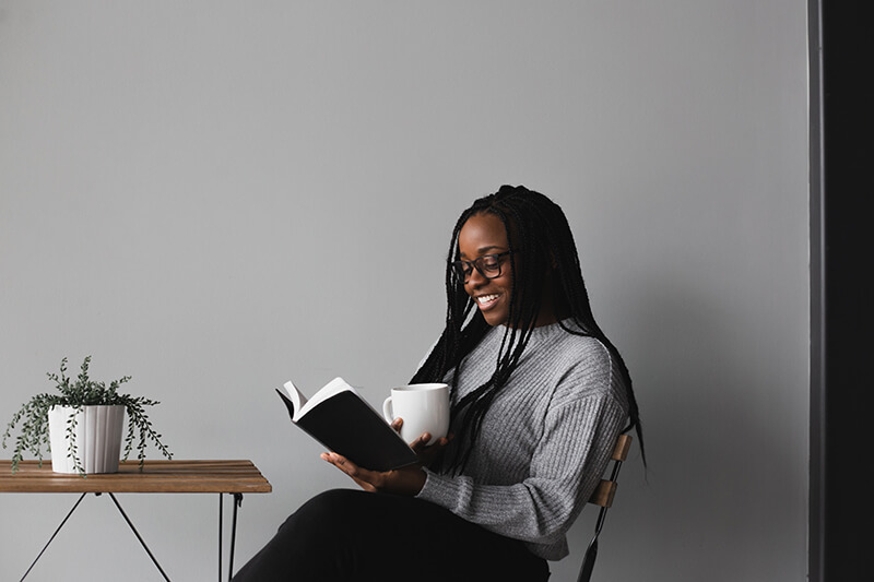 A woman reads as she prepares how to write a book review