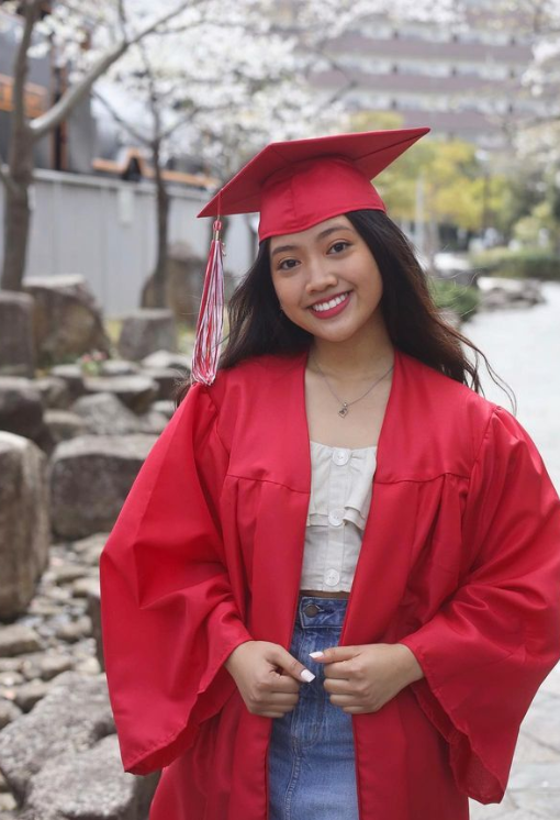 Jazmyne wears a cap and gown during her high school graduation