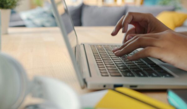 A university student using a variety of AI tools for students on their laptop and tablet.