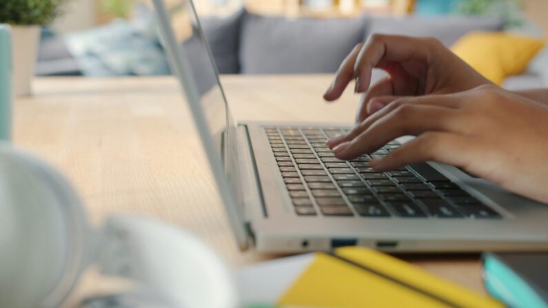 A university student using a variety of AI tools for students on their laptop and tablet.