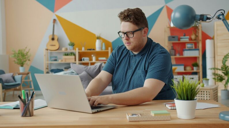 man researching on Expository Essay Topics